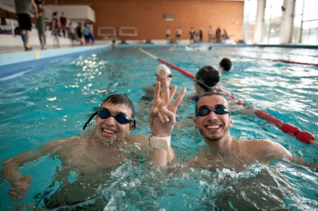 deux étudiants dans une piscine attachés ensemble par le poignet